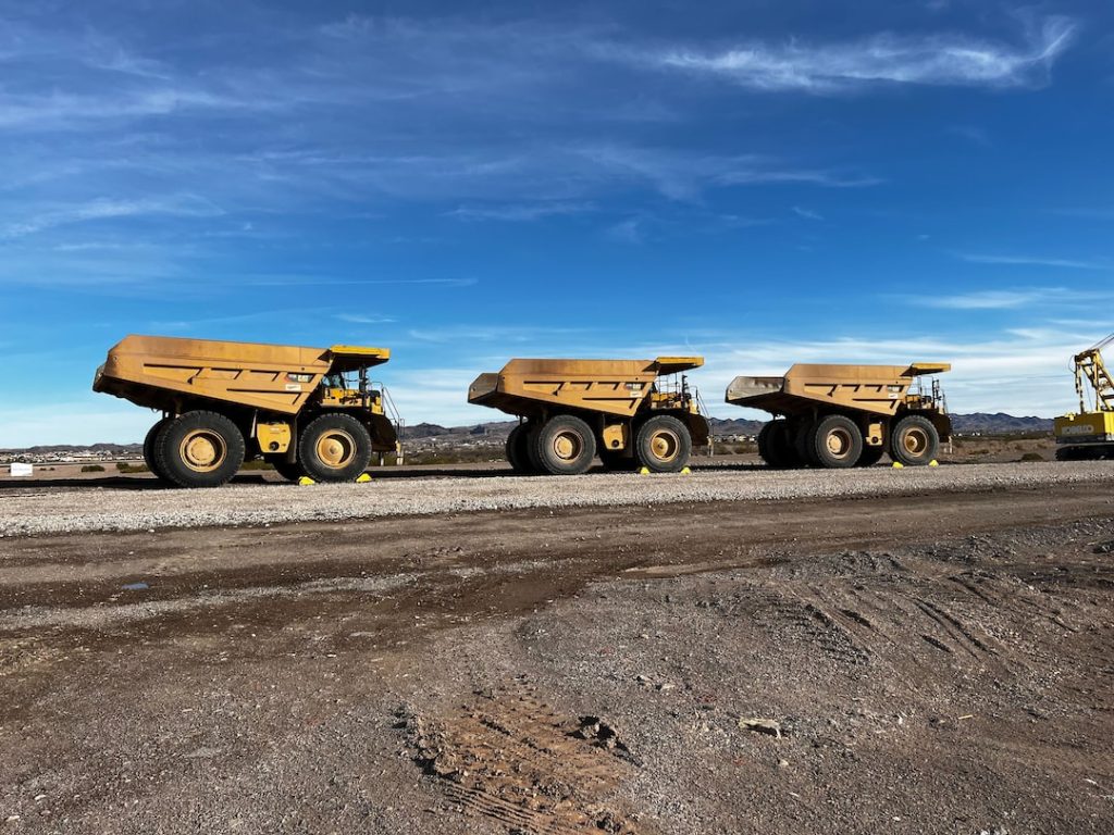 Three Caterpillar 777G mining haul trucks at work in Nevada.